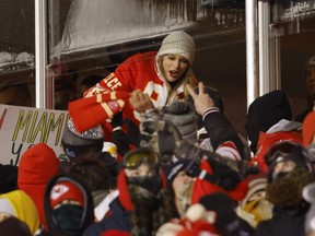 Taylor Swift celebrates with fans during the AFC Wild Card Playoffs between the Miami Dolphins and the Kansas City Chiefs.