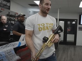 UFC champion Sean Strickland was gifted a golden gun by his manager.