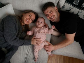 Baby Emmy Cogan 'is a wiggler and is full of smiles.' Seen here with parents Alicia Racine and Mike Cogan, she was born prematurely.