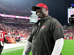 Head coach Todd Bowles of the Tampa Bay Buccaneers smiles as he walks off the field after defeating the Philadelphia Eagles.