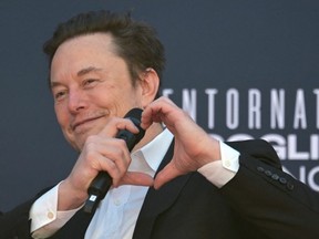 X (formerly Twitter) CEO Elon Musk makes a heart with his hands during the Atreju political meeting organised by the young militants of Italian right wing party Brothers of Italy (Fratelli d'Italia) on December 16, 2023 at the Sant'Angelo Castle in Rome.