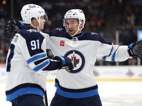 ANAHEIM, CALIFORNIA - JANUARY 05: Neal Pionk #4 congratulates Cole Perfetti #91 of the Winnipeg Jets after his goal during the third period of a game against the Anaheim Ducks at Honda Center on January 05, 2024 in Anaheim, California. (Photo by Sean M. Haffey/Getty Images)