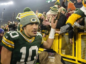 Jordan Love of the Green Bay Packers high-fives fans after a win over the Chicago Bears at Lambeau Field on Sunday, Jan. 7, 2024, in Green Bay, Wis.