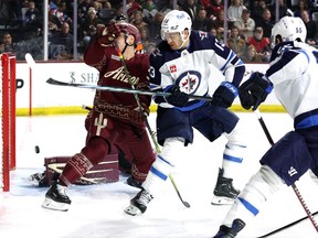 Gabriel Vilardi (13) of the Winnipeg Jets deflects a puck past Travis Dermott (33) of the Arizona Coyotes during the first period at Mullett Arena on Jan. 7, 2024 in Tempe, Ariz.