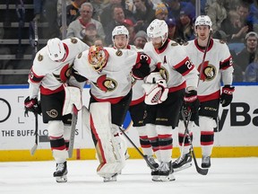 Anton Forsberg of the Ottawa Senators is helped off the ice by teammates after being injured during the first period against the Buffalo Sabres at KeyBank Center on Jan. 11, 2024 in Buffalo, New York.