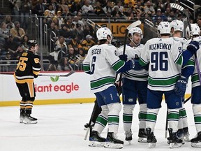 The Vancouver Canucks celebrate a goal by Brock Boeser in the first period against the Pittsburgh Penguins at PPG PAINTS Arena on January 11, 2024 in Pittsburgh, Pennsylvania.