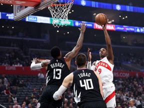 RJ Barrett #9 of the Toronto Raptors shoots over the defence of Ivica Zubac #40 and Paul George #13 of the LA Clippers during the first half of a game at Crypto.com Arena on January 10, 2024 in Los Angeles, California.