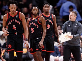 Darko Rajakovic, right, head coach of the Toronto Raptors, talks with Scottie Barnes (4), Immanuel Quickley (5) and RJ Barrett (9) during the second half of their NBA game against the Boston Celtics at Scotiabank Arena on Jan. 15, 2024, in Toronto.