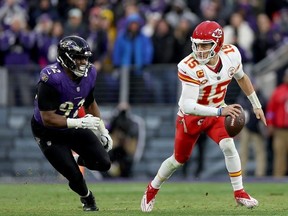 Patrick Mahomes #15 of the Kansas City Chiefs scrambles under pressure from Justin Madubuike #92 of the Baltimore Ravens during the second quarter in the AFC Championship Game at M&T Bank Stadium on January 28, 2024 in Baltimore, Maryland.