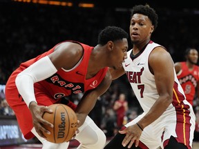 Raptors guard RJ Barrett (9) protects the ball from Miami Heat guard Kyle Lowry (7) during first half in Toronto on Wednesday.