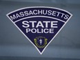 The seal of the Commonwealth of Massachusetts is displayed on a Massachusetts State Police cruiser parked outside the Statehouse, March 3, 2023, in Boston.