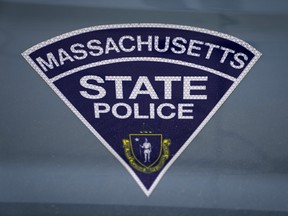 The seal of the Commonwealth of Massachusetts is displayed on a Massachusetts State Police cruiser parked outside the Statehouse, March 3, 2023, in Boston.