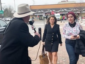 David Menzies, a reporter with Rebel News, walked up to Deputy PM Chrystia Freeland, centre, to ask her questions in Richmond Hill on Monday.