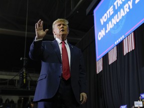 Republican presidential candidate former President Donald Trump gesturing to the crowd after speaking during a campaign event in Manchester, N.H., Saturday, Jan. 20, 2024.