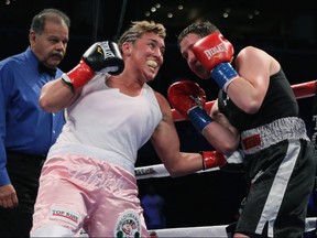 Christy Martin connects to the body of Dakota Stone as referee David Mendoza looks on during their welterweight bout at Staples Center on June 4, 2011 in Los Angeles, California.