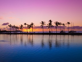A beautiful sunset graces a Hawaiian beach.