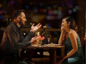 Young man telling funny stories to young woman on first date.