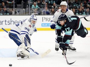 Leafs goalie Ilya Samsonov makes a save as Kraken forward Jaden Schwartz attempts to redirect the puck during the second period at Climate Pledge Arena on Sunday in Seattle.