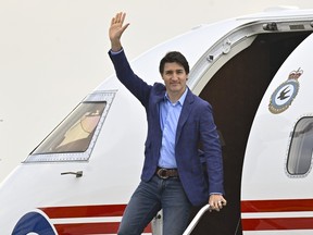 Prime Minister Justin Trudeau waves as he steps off a plane, Wednesday, June 14, 2023, at CFB Bagotville in Saguenay, Que.