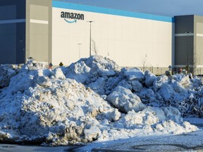 Piles of snow and ice that were plowed from parking spaces sit outside of the Amazon plant in Talbotville, south of London, on Wednesday, Jan. 17, 2024. (Derek Ruttan/The London Free Press)