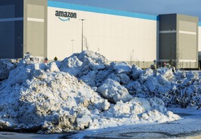 Piles of snow and ice that were plowed from parking spaces sit outside of the Amazon plant in Talbotville, south of London, on Wednesday, Jan. 17, 2024. (Derek Ruttan/The London Free Press)