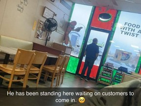 Customer Nick Chappell took this photo of Spirals eatery owner Scott Hosek looking out the front door while business was slow, in Norman, Okla., on Dec. 20.