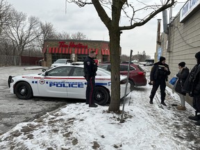 Durham Regional Police officers patrol the area checking up on the transient population at a Tim Hortons on Simcoe St. S. in Oshawa – which recently closed its dining area to in-store customers because the homeless population has been using the store for shelter and its washrooms to do drugs – on Thursday, Jan. 18, 2024.