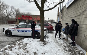 Durham Regional Police officers patrol the area checking up on the transient population at a Tim Hortons on Simcoe St. S. in Oshawa – which recently closed its dining area to in-store customers because the homeless population has been using the store for shelter and its washrooms to do drugs – on Thursday, Jan. 18, 2024.