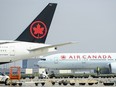 Air Canada planes sit on the tarmac at Pearson International Airport in Toronto on Wednesday, April 28, 2021.