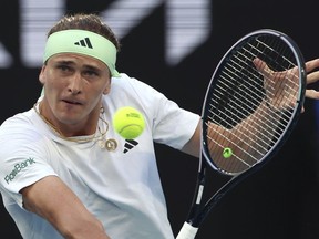 Alexander Zverev of Germany plays a backhand return to compatriot Dominik Koepfer during their first round match at the Australian Open tennis championships at Melbourne Park, Melbourne, Australia, Tuesday, Jan. 16, 2024.