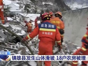 In this image taken from video footage run by China's CCTV, rescue workers search through rubble in the aftermath of a landslide in liangshui village in southwestern China's Yunnan Province on Monday, Jan. 22, 2024.