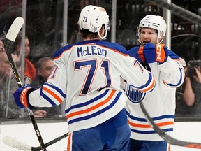 Edmonton Oilers left wing Warren Foegele, right, celebrates his goal with center Ryan McLeod during the second period of an NHL hockey game against the Anaheim Ducks Sunday, Dec. 31, 2023, in Anaheim, Calif.