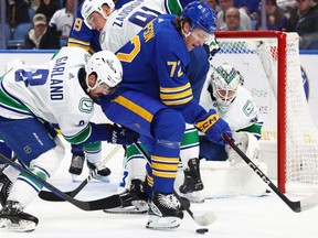 Vancouver Canucks right wing Conor Garland takes the puck from Buffalo Sabres right wing Tage Thompson during the first period of an NHL game Saturday, Jan. 13, 2024, in Buffalo, N.Y.