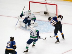 St. Louis Blues' Pavel Buchnevich is unable to score past Vancouver Canucks goaltender Thatcher Demko  and Ian Cole  during the first period of an NHL game Thursday, Jan. 4, 2024, in St. Louis.