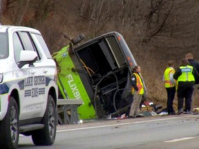 This still image from WTEN-TV video shows emergency response personnel at the site of a roll-over bus accident on the Adirondack Northway, in the town of Lake George, N.Y., on Friday, Jan. 5, 2024.