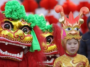 A Chinese young performer dressed in dragon costumes prepares to perform at a temple fair to celebrate the Lunar New Year of Dragon on January 22, 2012 in Beijing, China. (Getty Images)