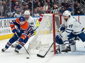 Ryan Nugent-Hopkins (93) of the Edmonton Oilersrounds the net and is faced with Noah Gregor(18) of the Toronto Maple Leafs at Rogers Place in Edmonton on Jan.16 2024. Photo by Shaughn Butts-Postmedia