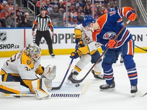 Zach Hyman (18) of the Edmonton Oilers, can't handle the rebound in front of goalie Kevin Lankinen(32) of the Nashville Predators at Rogers Place in Edmonton on Jan.27, 2024.