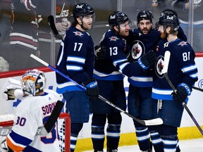 Winnipeg Jets' Gabriel Vilardi (13) celebrates his goal against the New York Islanders with Dylan Demelo (2), Kyle Connor (81) and Adam Lowry (17) during the first period of NHL action in Winnipeg on Tuesday January 16, 2024.