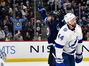 Winnipeg Jets' Alex Iafallo (9) celebrates his goal as Tampa Bay Lightning's Calvin de Haan (44) skates back to the bench during the second period of NHL action in Winnipeg, Tuesday, Jan. 2, 2024.