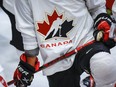 A Hockey Canada logo is shown on the jersey of a player with Canada’s National Junior Team during a training camp practice in Calgary.