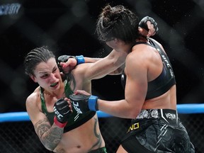 Raquel Pennington, left, fights Mayra Bueno Silva during a women's bantamweight title bout at UFC 297 in Toronto on Sunday, January 21, 2024.&