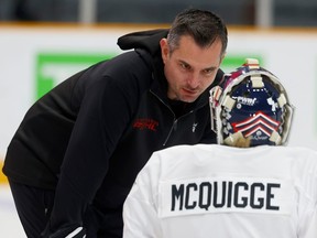 Goalie coach Pierre Groulx talks to goalie Rachel McQuigge.