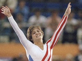 Mary Lou Retton celebrates her balance beam score at the 1984 Olympic Games, Aug. 3, 1984 in Los Angeles.