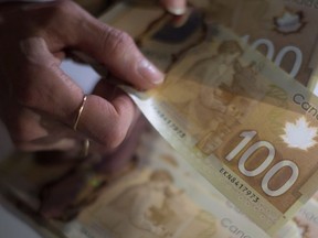 Canadian $100 bills are counted in Toronto on Tuesday, Feb. 2, 2016.