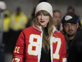 Taylor Swift wears a Kansas City Chiefs tight end Travis Kelce jacket as she arrives before an NFL wild-card playoff football game between the Chiefs and the Miami Dolphins, Saturday, Jan. 13, 2024, in Kansas City, Mo.