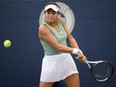 Carol Zhao, of Canada, returns the ball during a match against Amanda Anisimova, of the USA, at the National Bank Open tennis tournament in Toronto, on Tuesday, Aug. 9, 2022.