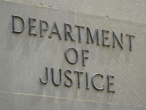 An exterior sign is photographed outside the Robert F. Kennedy Department of Justice building in Washington on May 4, 2021.