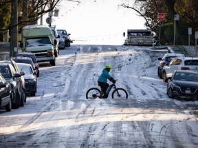 A cyclist bikes across an icy hill in Vancouver on Friday, Jan. 12, 2024.