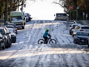 Weather warnings cover much of Canada this weekend, from arctic outflows on British Columbia's coast to extreme cold through the Prairies and storms through southern Ontario, Quebec and the Maritimes. A cyclist bikes across an icy hill in Vancouver on Friday, Jan. 12, 2024.